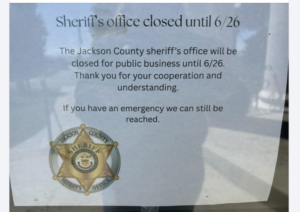 A piece of paper taped to a glass door